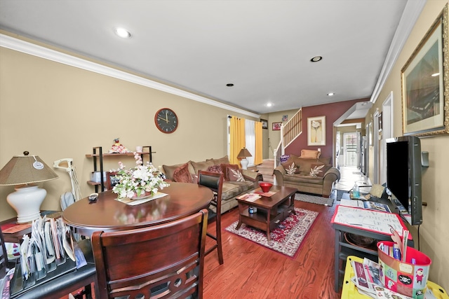 living room with ornamental molding and hardwood / wood-style flooring