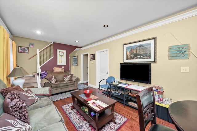 living room with crown molding and hardwood / wood-style flooring