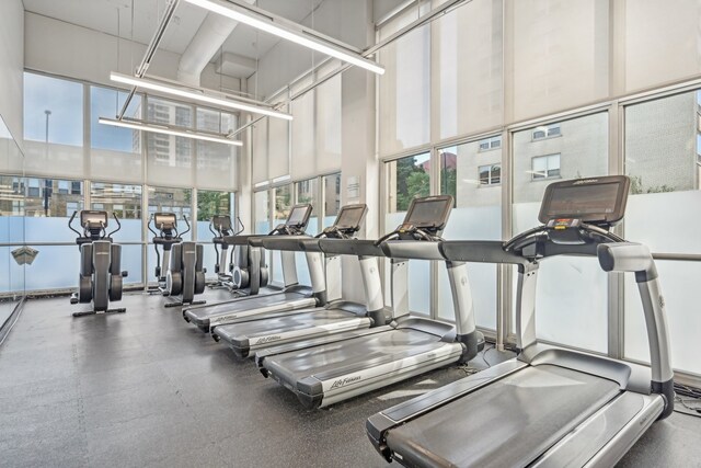 exercise room with a towering ceiling