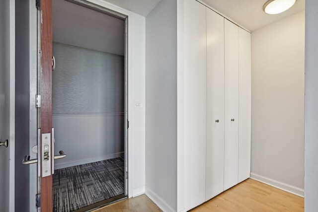 corridor with light wood-type flooring