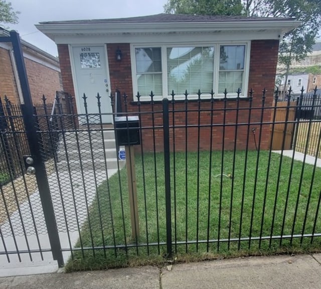 view of gate featuring a lawn