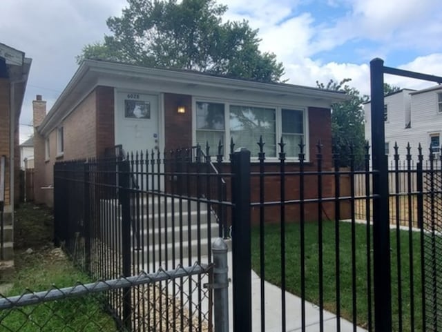 view of gate with a yard