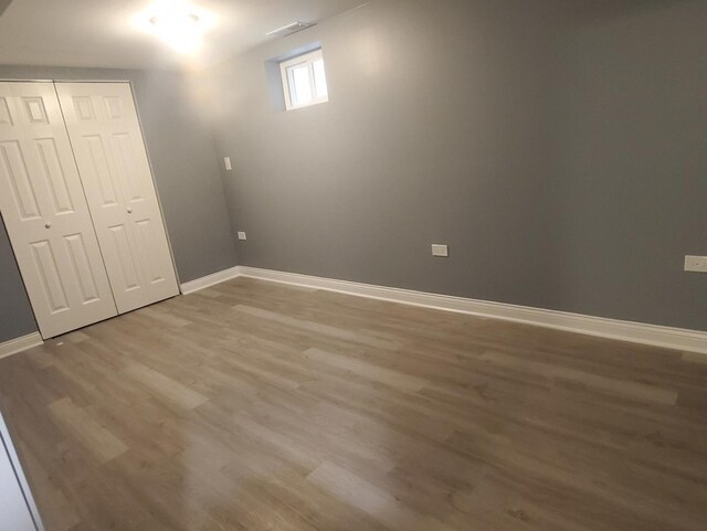 unfurnished bedroom featuring hardwood / wood-style floors and a closet