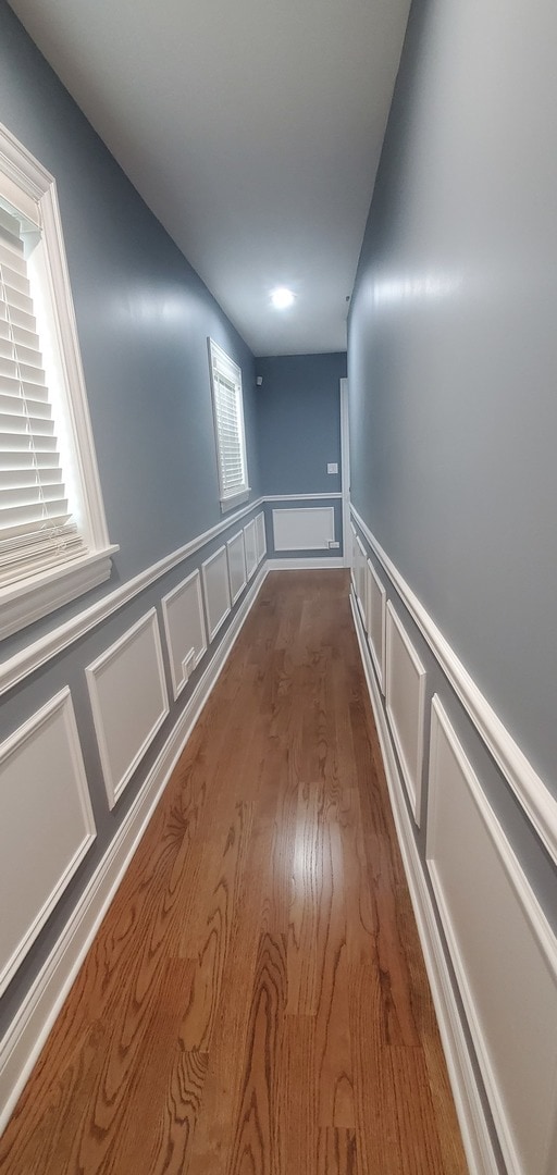 corridor with dark hardwood / wood-style flooring