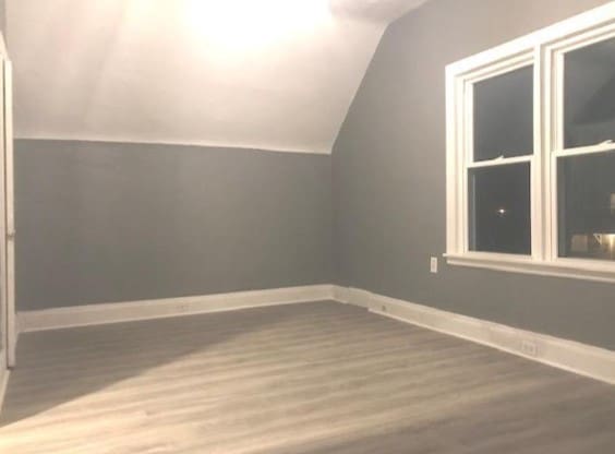 bonus room with hardwood / wood-style flooring and lofted ceiling