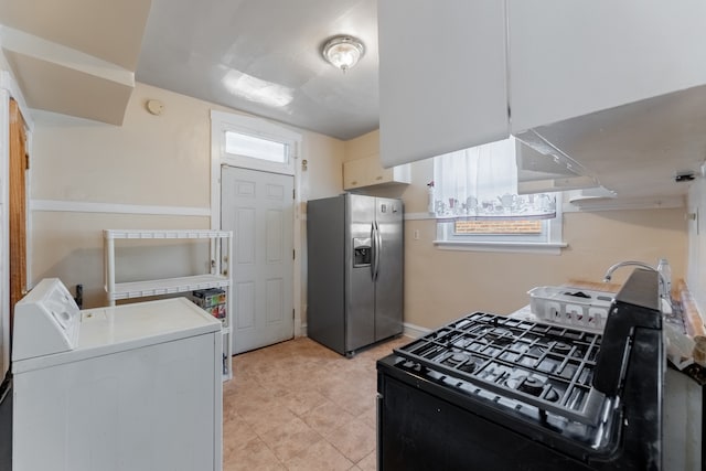 kitchen with stainless steel fridge with ice dispenser, black gas range, and washer / clothes dryer