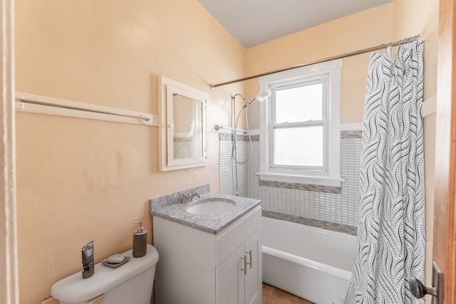 full bathroom featuring vanity, shower / bath combo with shower curtain, and toilet