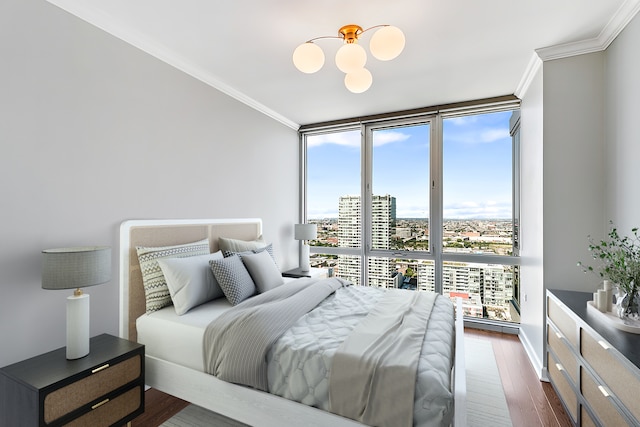 bedroom with crown molding, wood-type flooring, and multiple windows