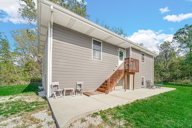 back of house featuring a yard and a patio