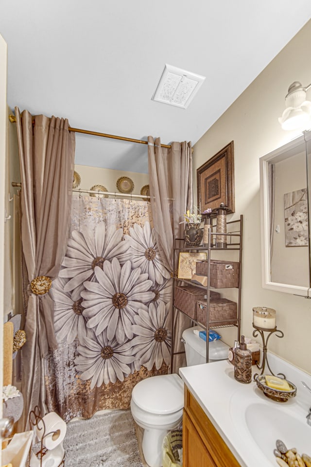 bathroom featuring toilet, a shower with curtain, and vanity