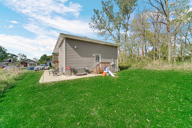 rear view of house with a yard and a patio area