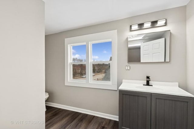 bathroom featuring hardwood / wood-style flooring, vanity, and toilet