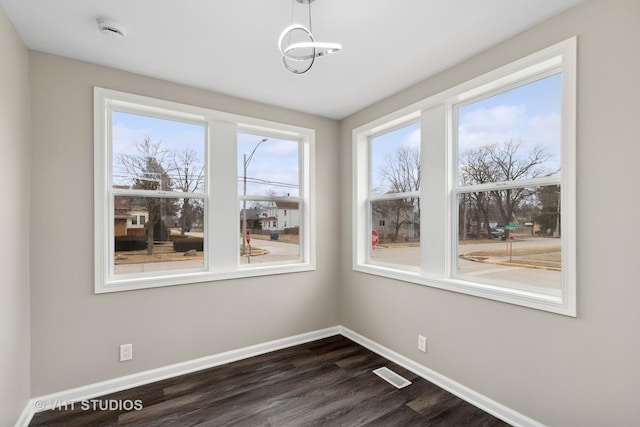 unfurnished dining area featuring dark hardwood / wood-style floors