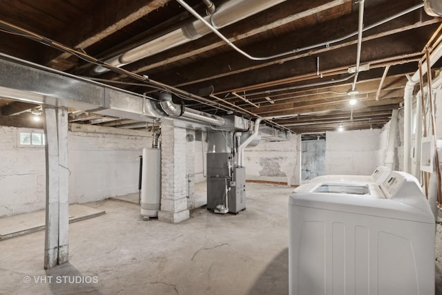 basement with washer and clothes dryer, gas water heater, and heating unit