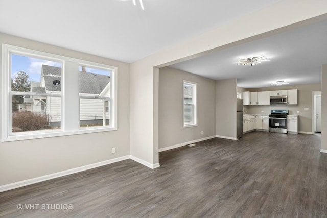 unfurnished living room with dark wood-type flooring