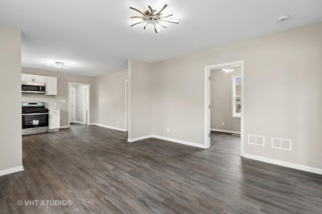 unfurnished living room featuring dark wood-type flooring