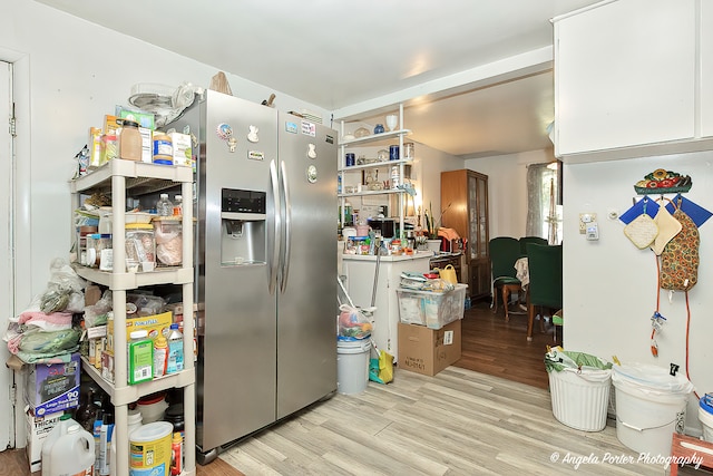 kitchen with light hardwood / wood-style floors and white cabinetry