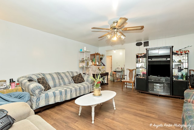 living room with hardwood / wood-style flooring and ceiling fan