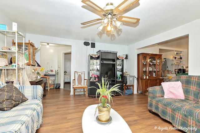 living room featuring ceiling fan and hardwood / wood-style flooring