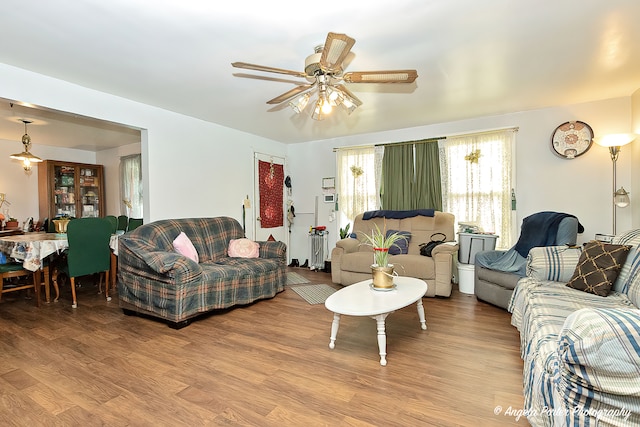 living room with light wood-type flooring and ceiling fan