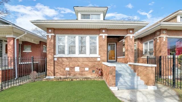 view of front of house with brick siding, a front yard, and fence