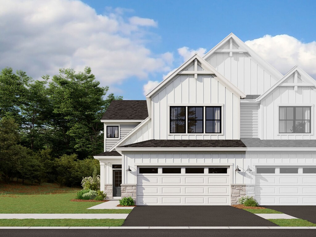 view of front of home with a front lawn and a garage