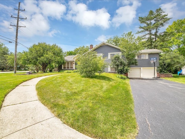 view of front of house with a garage and a front lawn