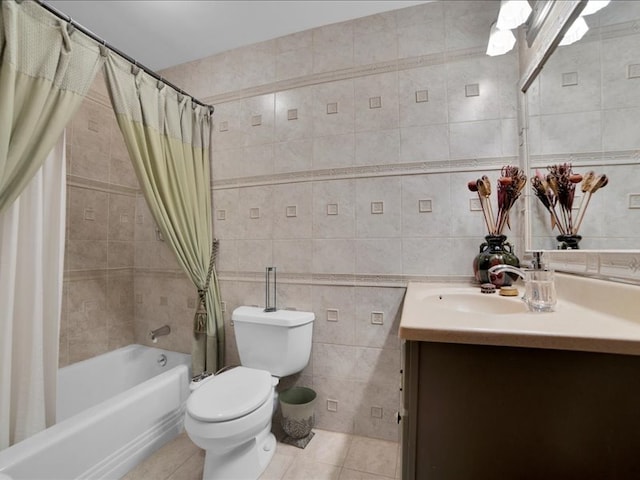 full bathroom with toilet, tile patterned flooring, vanity, shower / bath combo, and tile walls