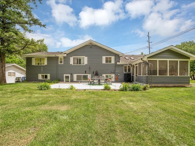 rear view of property with a patio area, a sunroom, and a lawn