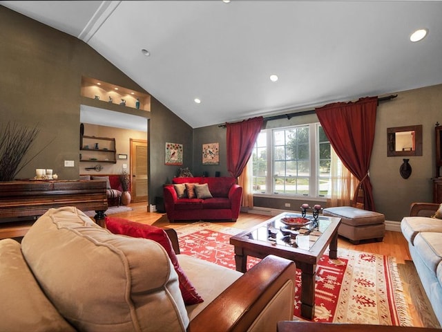 living room with vaulted ceiling and light hardwood / wood-style flooring