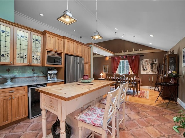 kitchen featuring pendant lighting, tasteful backsplash, wine cooler, lofted ceiling, and stainless steel appliances