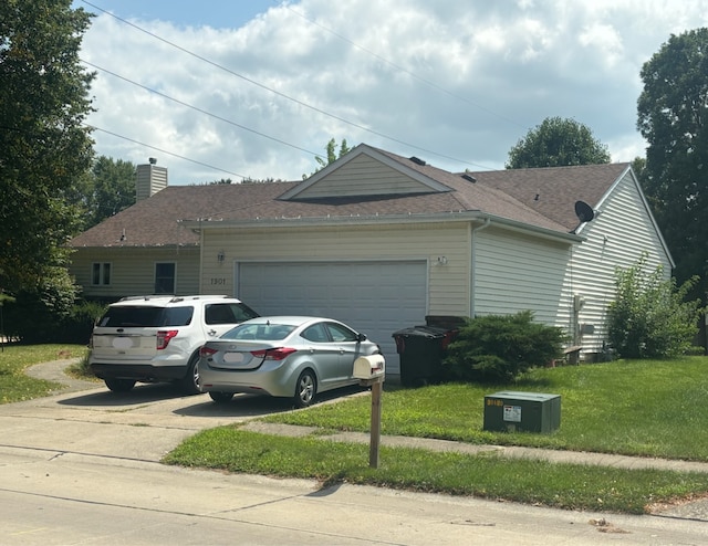 view of side of property with a yard and a garage