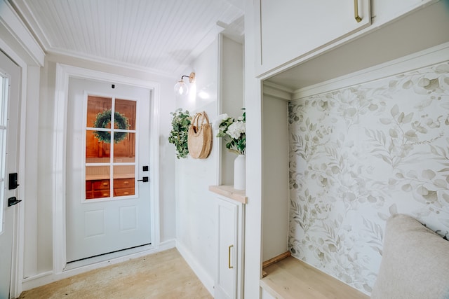 doorway featuring light wood-type flooring and crown molding