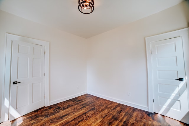 empty room with dark hardwood / wood-style flooring