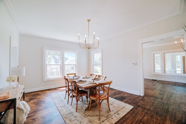 dining area with dark hardwood / wood-style floors, crown molding, and a notable chandelier