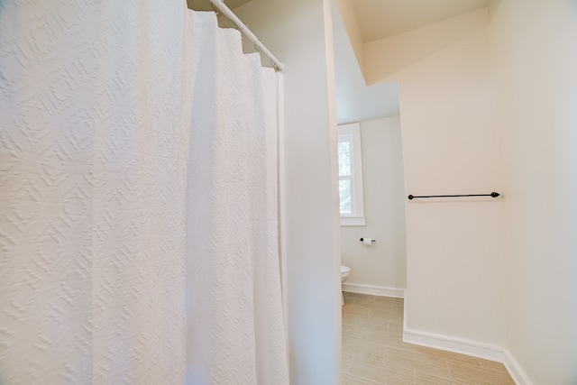 bathroom with toilet and tile patterned floors