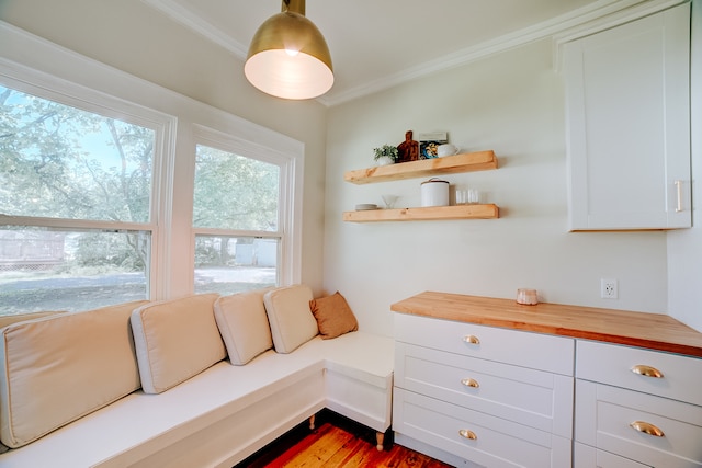 living room featuring crown molding and wood-type flooring