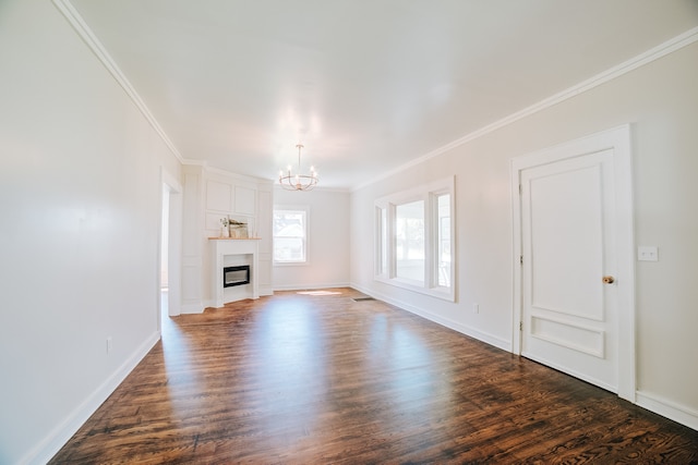 unfurnished living room featuring crown molding, wood-type flooring, and an inviting chandelier