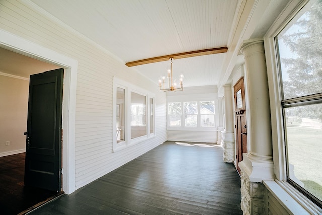 unfurnished sunroom featuring an inviting chandelier, decorative columns, and beam ceiling