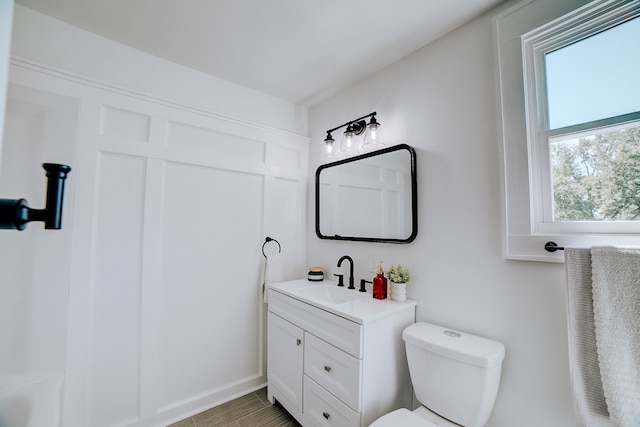 bathroom featuring toilet and vanity