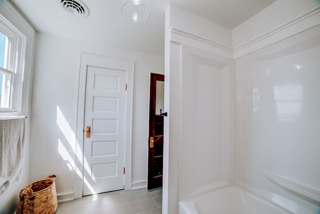 bathroom with bathing tub / shower combination