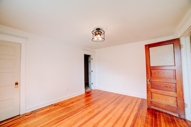 spare room with wood finished floors and baseboards