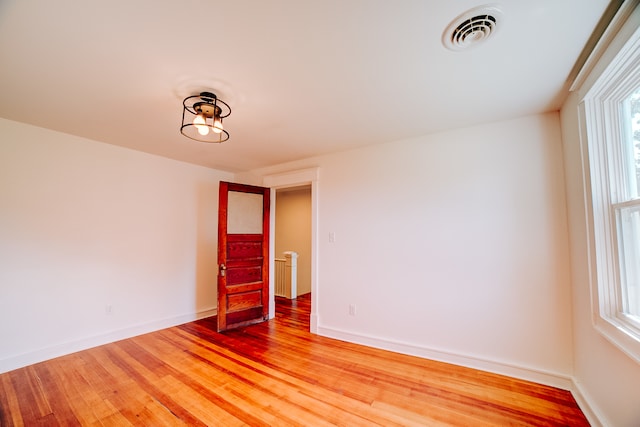 unfurnished room featuring hardwood / wood-style flooring