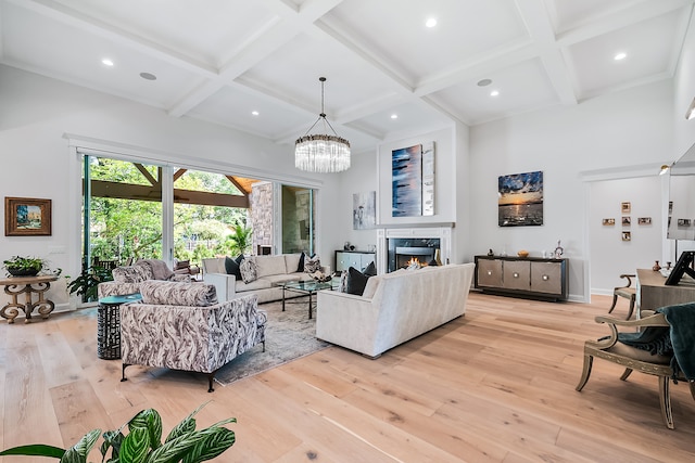 living room featuring beam ceiling, coffered ceiling, and light hardwood / wood-style flooring