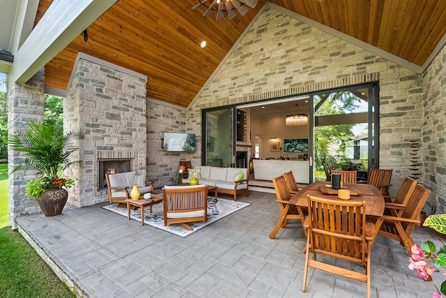 view of patio with an outdoor living space with a fireplace