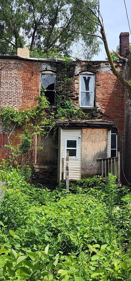 back of house featuring brick siding