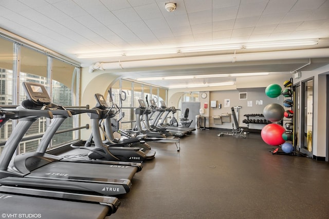 gym featuring floor to ceiling windows