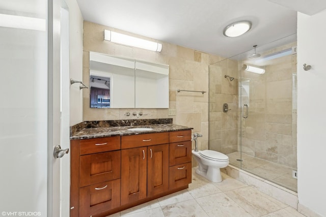 bathroom with walk in shower, tile patterned floors, vanity, and toilet