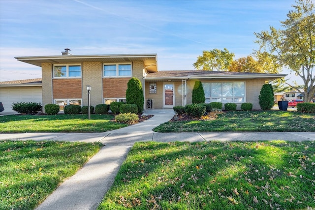 view of front of property featuring a front lawn and a garage