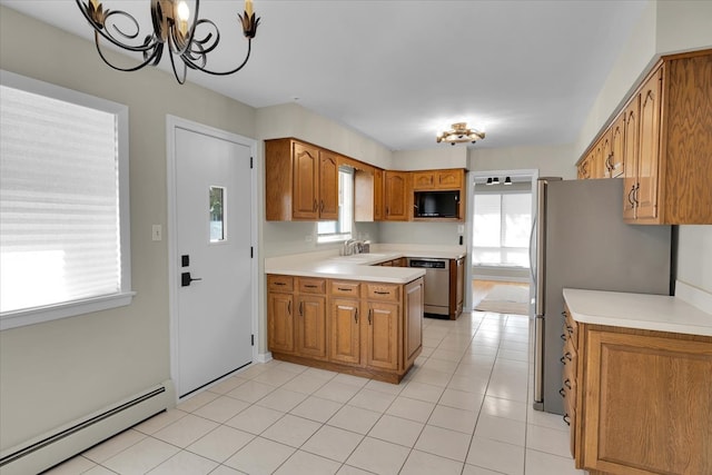 kitchen with a baseboard radiator, appliances with stainless steel finishes, an inviting chandelier, light tile patterned flooring, and sink